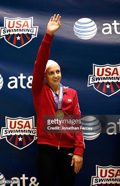 Rebecca Soni waves to the crowd after winning the gold medal in the 200 yard breaststroke during day three of the AT&T Short Course Nationals at...