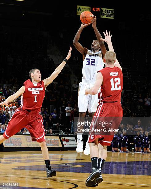 Forward Jamar Samuels of the Kansas State Wildcats puts up a shot against pressure from defenders Klay Thompson and Brock Motum of the Washington...