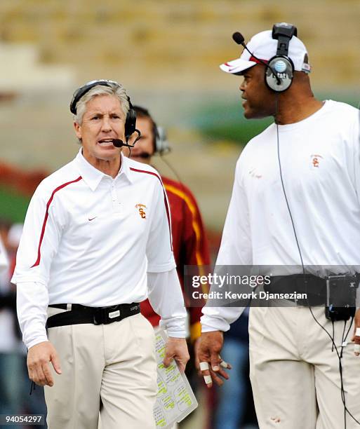 Coach Pete Carroll of the USC Trojans talks with Ken Norton Jr., Assistant Head Coach of the Defense/Linebackers during the fourth quarter of the...