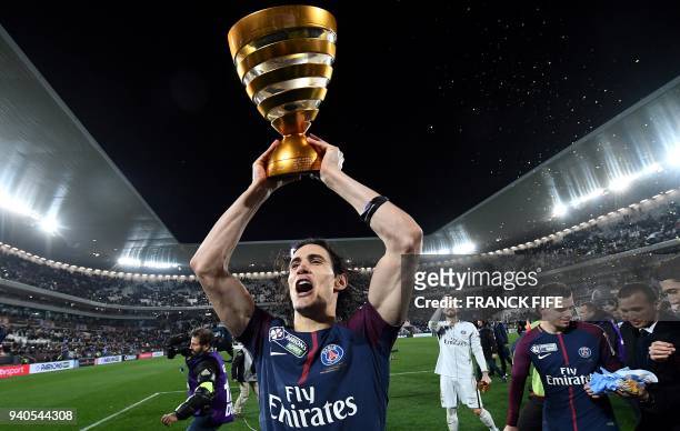 Paris Saint-Germain's Uruguayan forward Edinson Cavani holds his trophy after winning the French League Cup final football match between Monaco and...