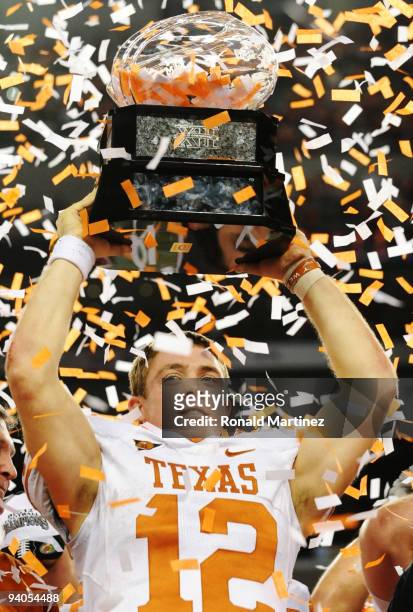 Quarterback Colt McCoy of the Texas Longhorns lifts the trophy after his teams 10-6 victory over the Nebraska Cornhuskers in the game at Cowboys...