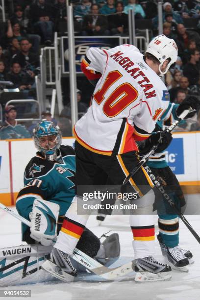 Brian McGrattan of the Calgary Flames blocks Evgeni Nabokov of the San Jose Sharks who searches for the puck during an NHL game on December 5, 2009...