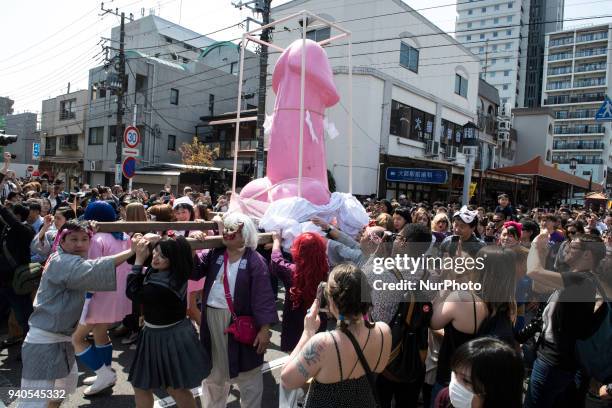 People carry a large pink phallus shaped portable shrine during the annual Kanamara Festival at Kanayama Shrine in Kawasaki on April 1 Kawasaki,...