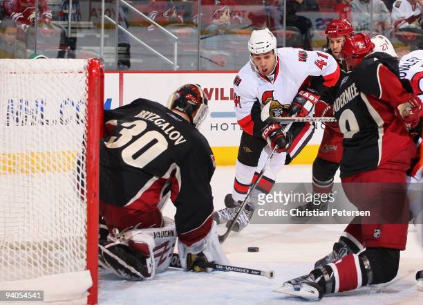 Jonathan Cheechoo of the Ottawa Senators skates in on goaltender Ilya Bryzgalov of the Phoenix Coyotes during the NHL game at Jobing.com Arena on...