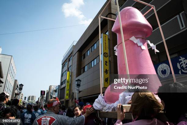 People carry a large pink phallus shaped portable shrine during the annual Kanamara Festival at Kanayama Shrine in Kawasaki on April 1 Kawasaki,...