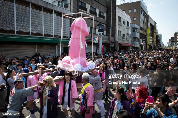 People carry a large pink phallus shaped portable shrine during the annual Kanamara Festival at Kanayama Shrine in Kawasaki on April 1 Kawasaki,...