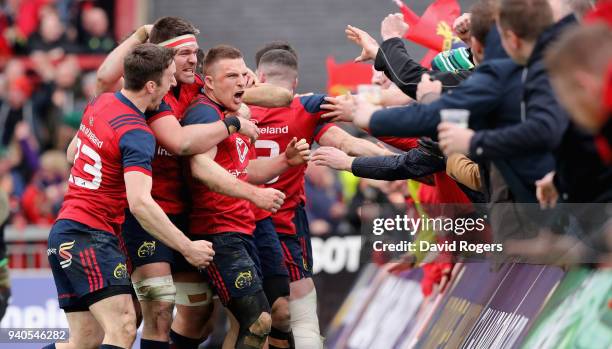 Andrew Conway of Munster celebrares with team mates after scoring a crucial late second half try during the European Rugby Champions Cup match...