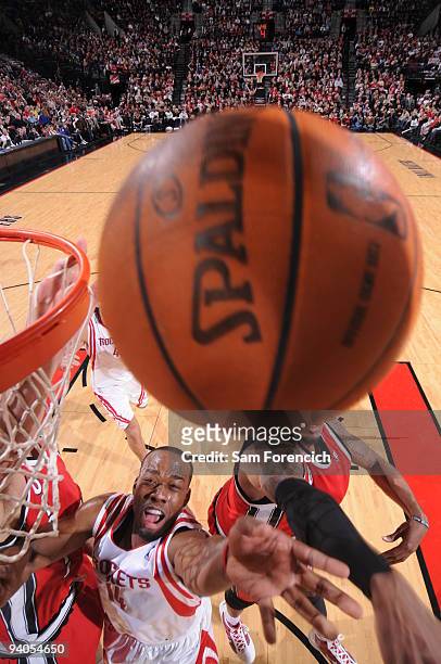 Carl Landry of the Houston Rockets grabs for the ball against LaMarcus Aldridge of the Portland Trail Blazers during a game on December 5, 2009 at...
