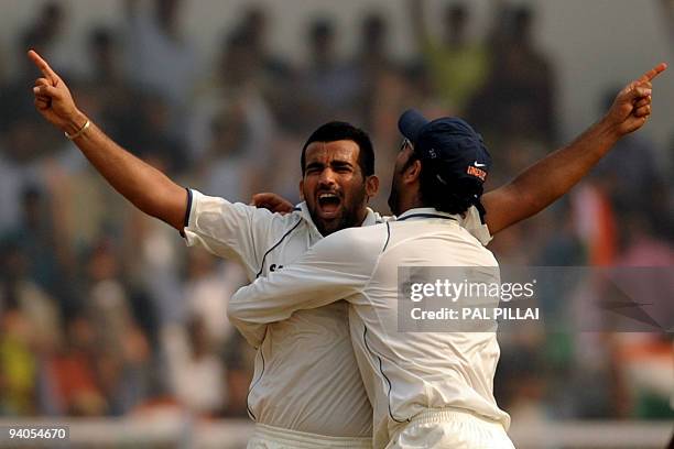 Indian cricketer Yuvraj singh hugs Zaheer Khan for taking the wicket of Sri Lanka's Nuwan Kulesakara on the final day of the third Test between India...