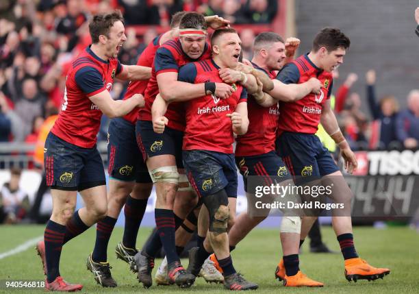 Andrew Conway of Munster celebrates with team mate and the crowd after scoring a crucial late second half try during the European Rugby Champions Cup...