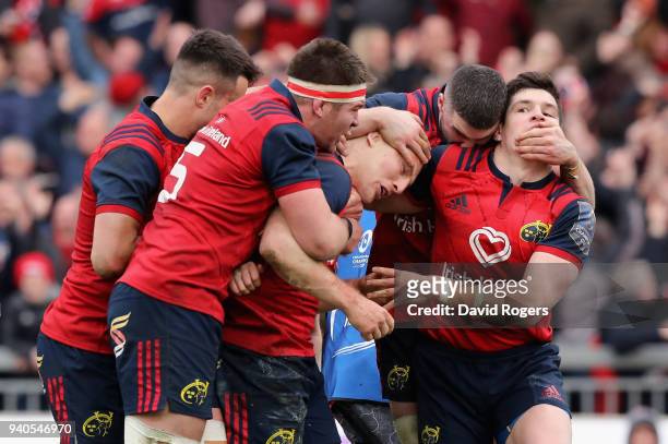 Andrew Conway of Munster celebrates with team mate and the crowd after scoring a crucial late second half try during the European Rugby Champions Cup...