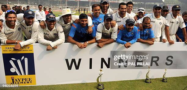 Indian cricketers pose for a team photo after winning on the final day of the third Test between India and Sri Lanka in Mumbai on December 6, 2009....