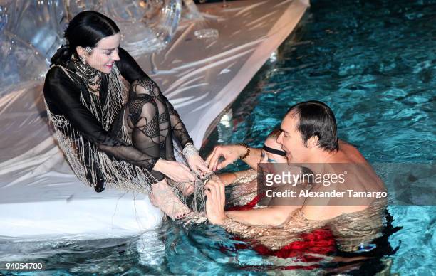 Daphne Guinness, make-up artist/model Sharon Gault and photographer David LaChapelle swim in the pool during the Maybach presents David LaChapelle's...