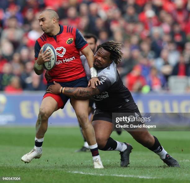 Simon Zebo of Munster is tackled by Mathieu Bastareaud during the European Rugby Champions Cup match between Munster Rugby and RC Toulon at Thomond...