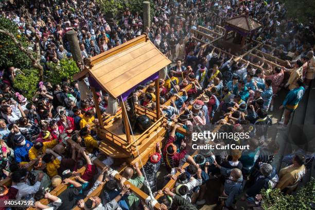 Large black phallic-shaped 'Mikoshi' is carried to Kanayama Shrine during Kanamara Matsuri on April 1, 2018 in Kawasaki, Japan. The Kanamara Festival...