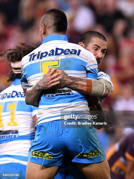Phillip Sami of the Titans celebrates with Nathan Peats after scoring a try during the round four NRL match between the Brisbane Broncos and the Gold...