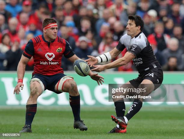 Francois Trinh-Duc of Toulon passes the ball watched by CJ Stander during the European Rugby Champions Cup match between Munster Rugby and RC Toulon...