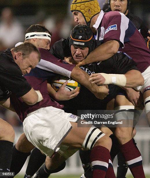 Hottie Louw of the Stormers is tackled by Matt Cockbain and Mark Connors of Queensland during the Super 12 Rugby Union match between the Queensland...