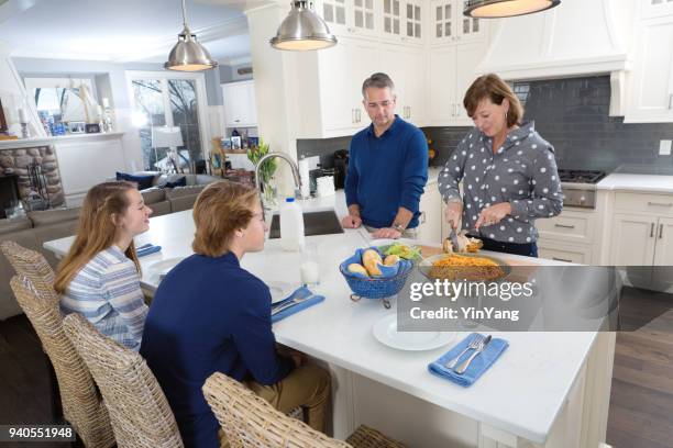 parents and children family lunch or dinner meal in kitchen counter - open grave stock pictures, royalty-free photos & images