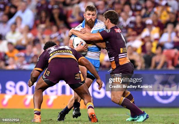 Will Matthews of the Titans takes on the defence during the round four NRL match between the Brisbane Broncos and the Gold Coast Titans at Suncorp...