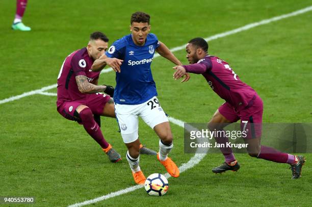 Dominic Calvert-Lewin of Everton runs with the ball despite challenges by Nicolas Otamendi of Manchester City and Raheem Sterling of Manchester City...
