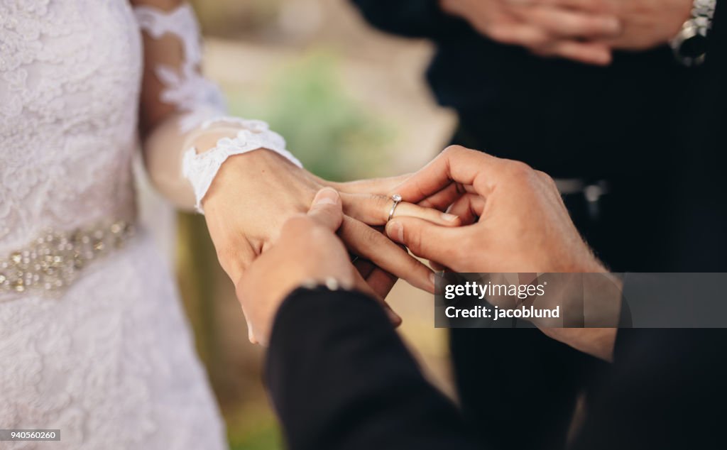 Echanging Rings Couple Exchanging Wedding Rings High-Res Stock Photo - Getty Images