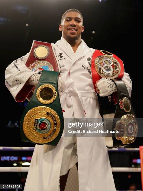 Anthony Joshua celebrates poses with his belts after his WBA, IBF, WBO & IBO Heavyweight Championship title fight against Joseph Parker at...