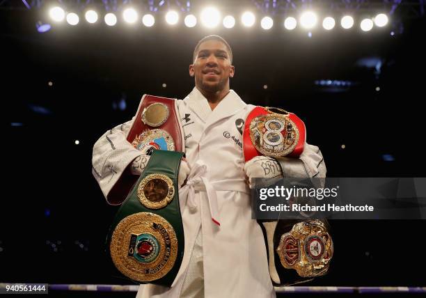 Anthony Joshua poses with his belts after his WBA, IBF, WBO & IBO Heavyweight Championship title fight at Joseph Parker Principality Stadium on March...