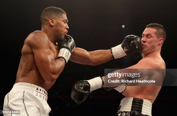 Anthony Joshua punches Joseph Parker during there WBA, IBF, WBO & IBO Heavyweight Championship title fight at Principality Stadium on March 31, 2018...