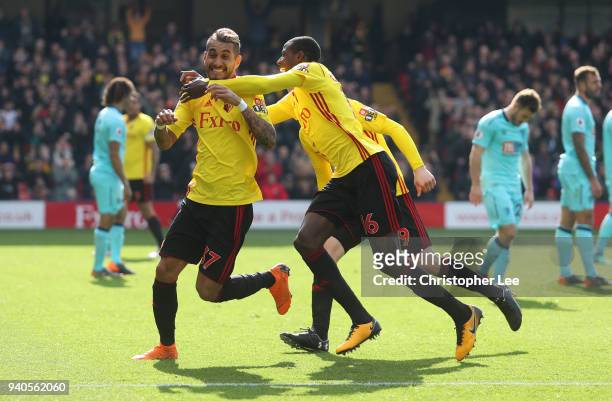 Roberto Pereyra of Watford celebrates after scoring with Abdoulaye Doucoure of Watford and Will Hughes of Watford during the Premier League match...