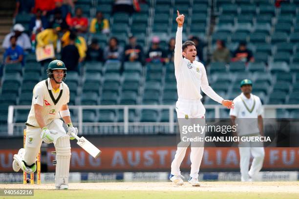 South African bowler Keshav Mahraj celebrates the dismissal of Australian batsman Pat Cummins on the third day of the fourth Test cricket match...