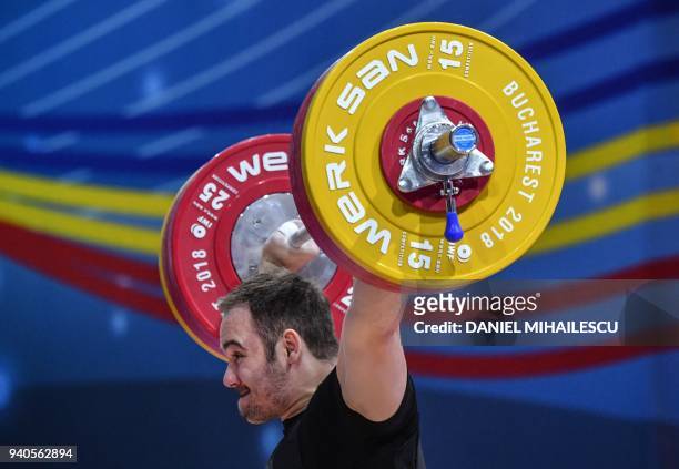 Philipp Forster of Austria lifts during the men's senior 105 kg category of the European Weightlifting Championship in Izvorani, April 1, 2018. / AFP...