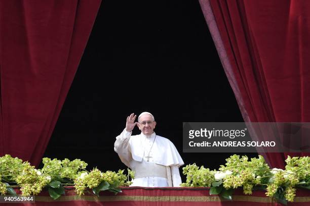 Pope Francis delivers the "Urbi et Orbi" blessing to the city and to the world from the balcony of St Peter's basilica after the Easter Sunday Mass...
