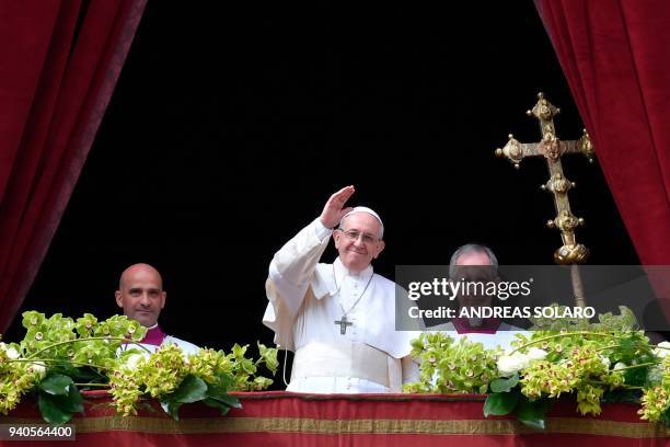 Pope Francis delivers the "Urbi et Orbi" blessing to the city and to the world from the balcony of St Peter's basilica after the Easter Sunday Mass...