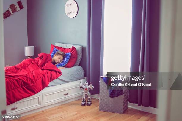 young boy in bed sleeping - child asleep in bedroom at night stock pictures, royalty-free photos & images