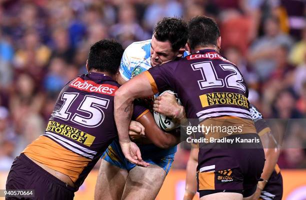 Morgan Boyle of the Titans takes on the defence during the round four NRL match between the Brisbane Broncos and the Gold Coast Titans at Suncorp...