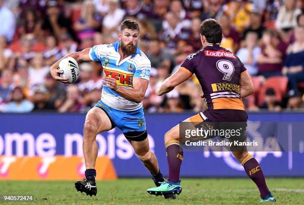 Will Matthews of the Titans takes on the defence during the round four NRL match between the Brisbane Broncos and the Gold Coast Titans at Suncorp...