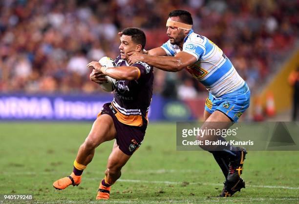 Kodi Nikorima of the Broncos is tackled by Ryan James of the Titans during the round four NRL match between the Brisbane Broncos and the Gold Coast...