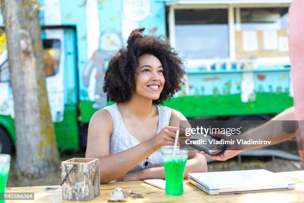 woman drinking cocktail and using credit card - food truck payments stock pictures, royalty-free photos & images