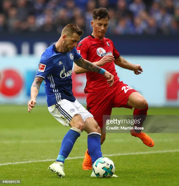 Guido Burgstaller of Schalke celebrates scores a goal to make it 2:0 past Robin Koch of Freiburg during the Bundesliga match between FC Schalke 04...