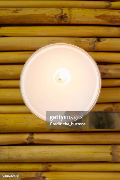 high angle view of a candle on bamboo, tranquil scene - candle overhead stock pictures, royalty-free photos & images