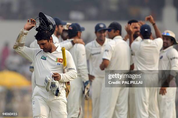 Sri Lankan cricketer Kumara Sangakara walks back to the pavilion after his team lost on the final day of the third Test between India and Sri Lanka...