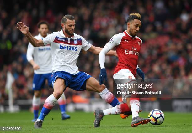 Pierre-Emerick Aubameyang of Arsenal is challenged by Erik Pieters of Stoke City during the Premier League match between Arsenal and Stoke City at...