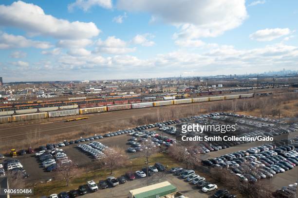 Aerial view of freight train yard with parking lot in foreground on a sunny day in Newark, New Jersey, March 16, 2018.
