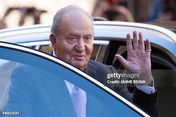 Former King Juan Carlos I of Spain waves as he leaves after attending the traditional Easter Sunday Mass of Resurrection in Palma de Mallorca on...