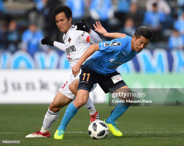 Kazuyoshi Miura of Yokohama FC and Takahide Umebachi of Zweigen Kanazawa compete for the ball during the J.League J2 match between Yokohama FC and...