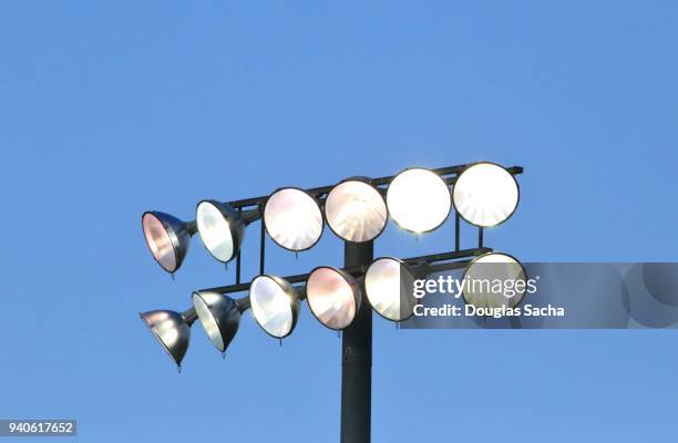 illuminated stadium overhead lights - floodlit stock pictures, royalty-free photos & images