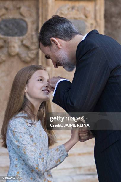 King Felipe VI of Spain jokes with his daughter Princess Leonor as they leave after attending the traditional Easter Sunday Mass of Resurrection in...