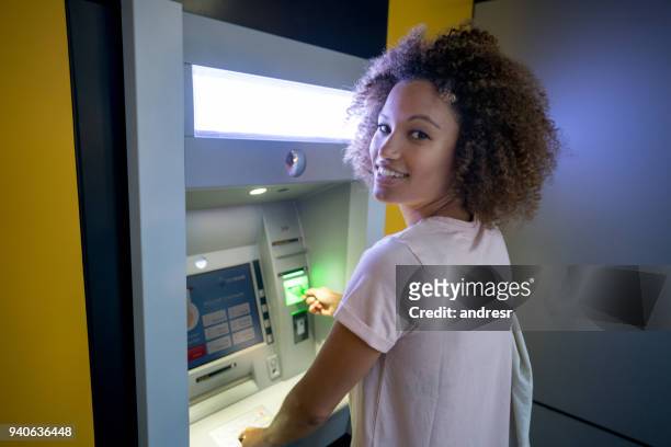 woman withdrawing cash at an atm - cash australia stock pictures, royalty-free photos & images