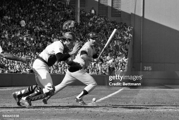 New York Yankees catcher, Thurman Munson, takes off bat in hand, as Red Sox catcher, Carlton Fisk, dropped the third strike in the 3rd inning of the...